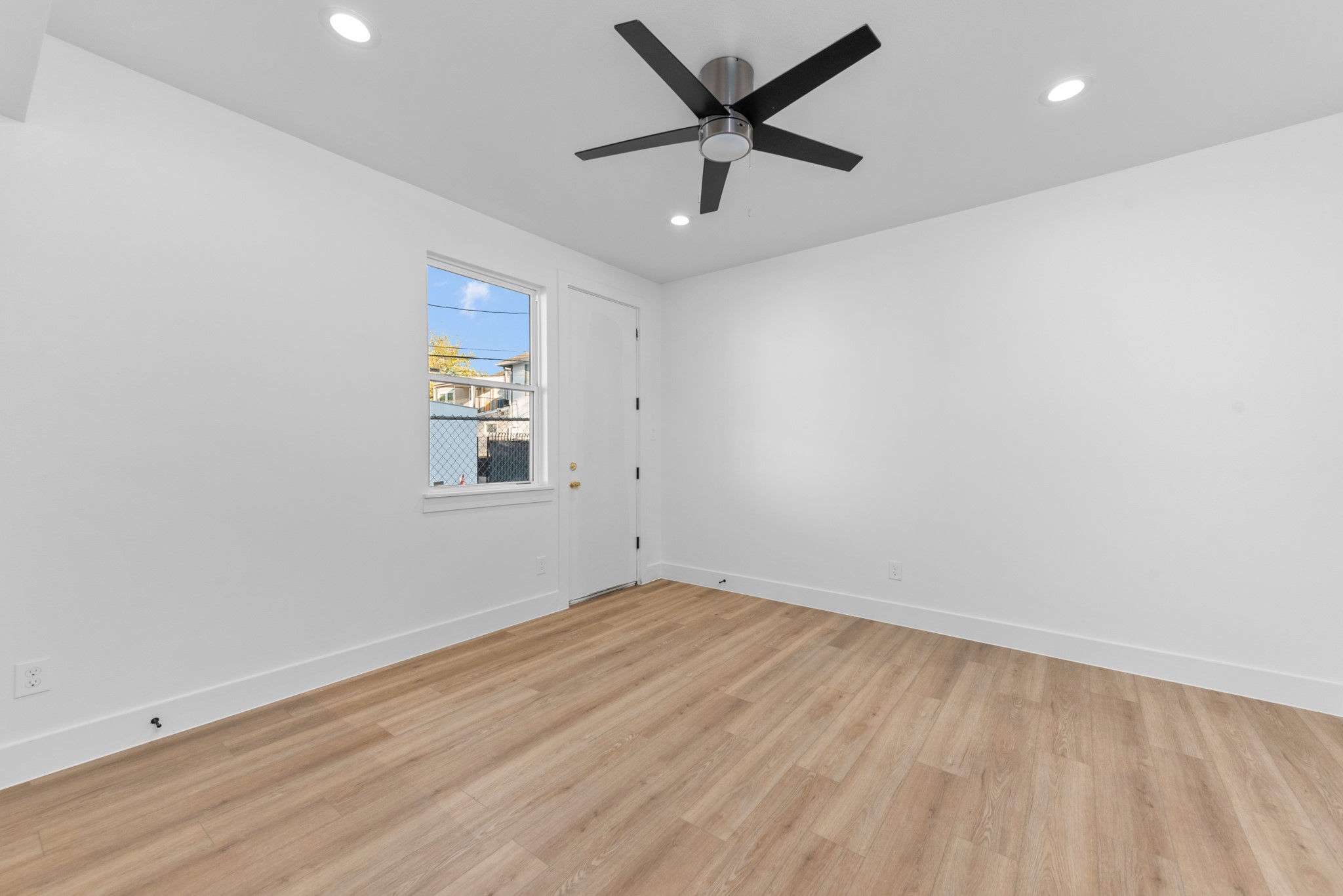 2314 Barbee Street Houston, TX 77004 - Photo 2 of 15 an empty room with wooden floor and windows