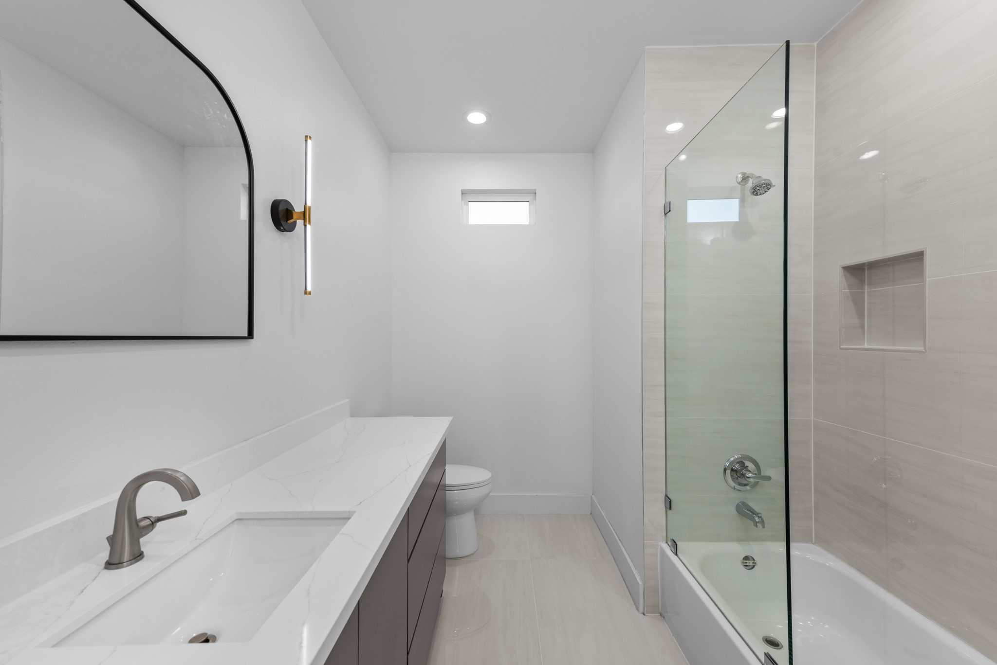 2314 Barbee Street Houston, TX 77004 - Photo 6 of 15 a bathroom with a sink and mirror with bathtub