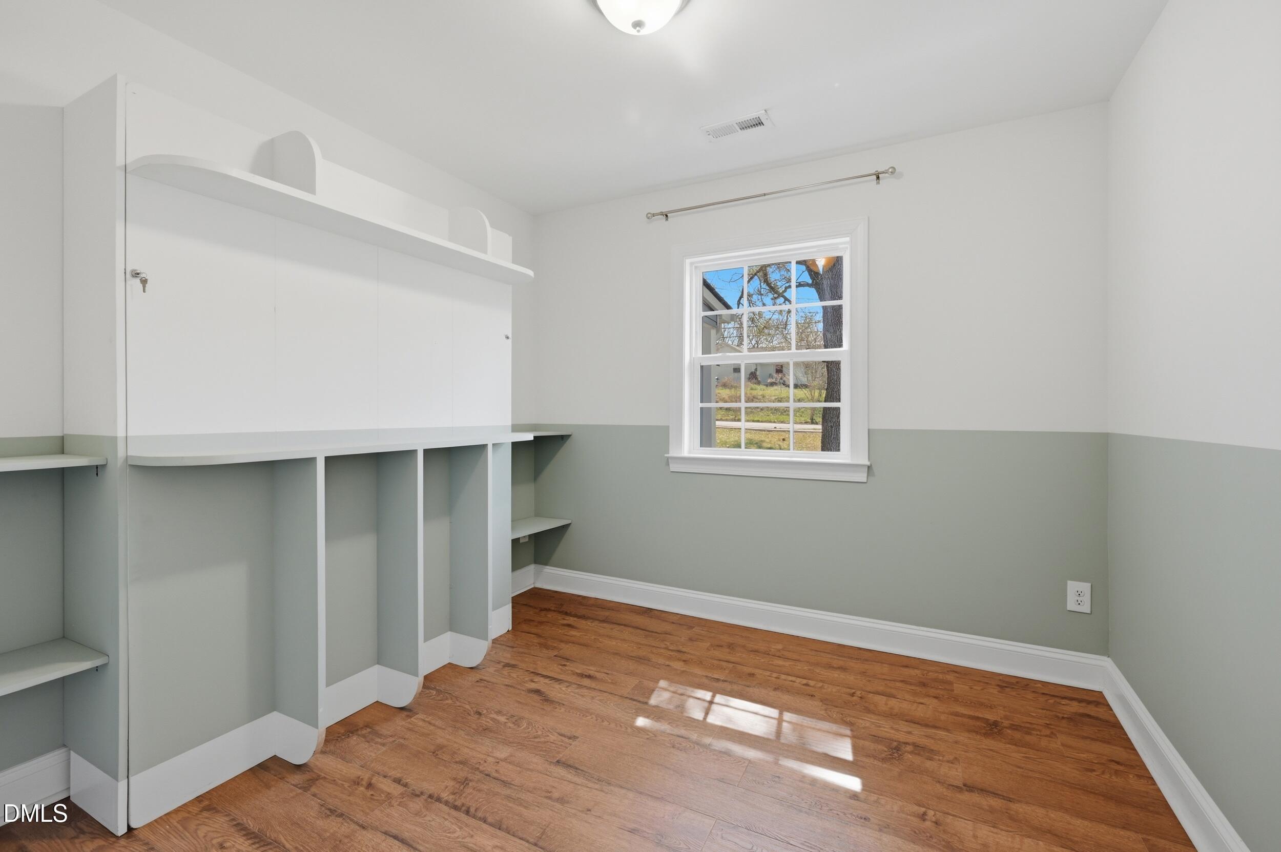 2301 Milburnie Road Raleigh, NC 27610 - Photo 17 of 23 a view of a room with wooden floor and cabinet