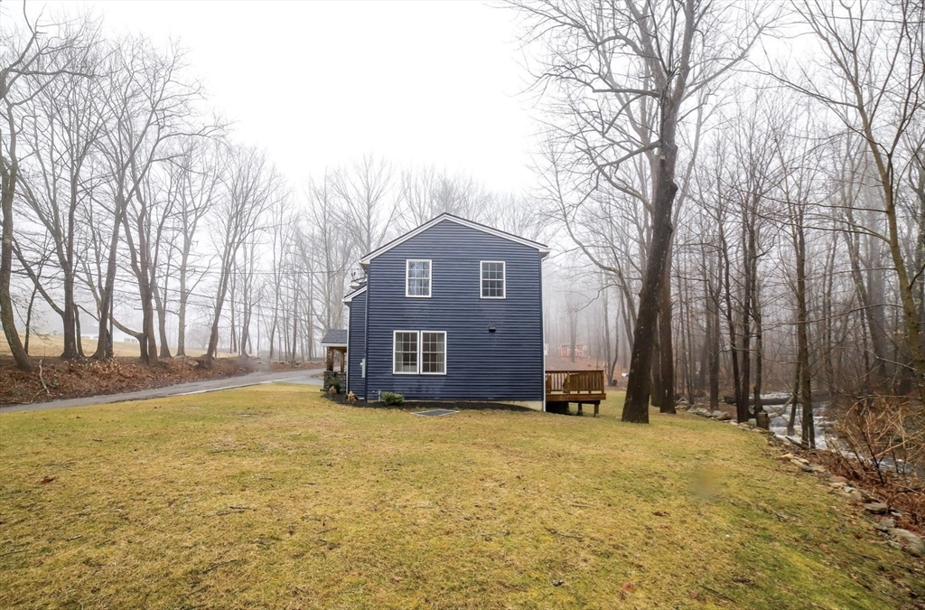 3 Woods Road Westminster, MA 01473 - Photo 35 of 41 a front view of house with yard and trees in the background