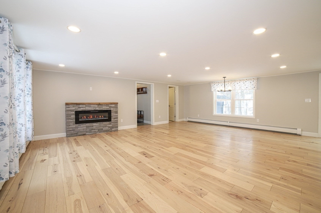 3 Woods Road Westminster, MA 01473 - Photo 7 of 41 a view of empty room with wooden floor and fireplace