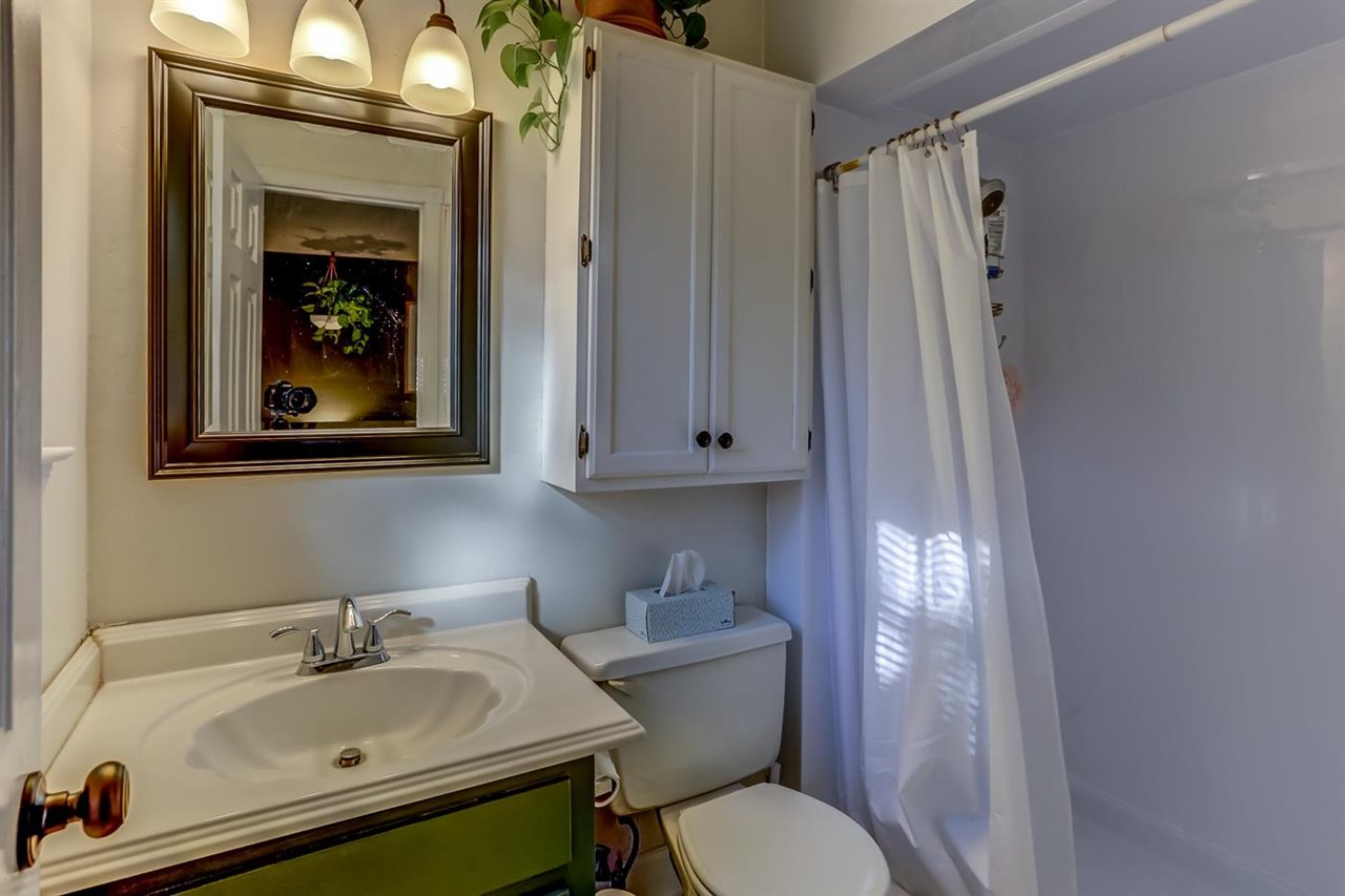 381 Rutledge Street Collierville, TN 38017 - Photo 16 of 23 a bathroom with a sink a toilet and shower curtain