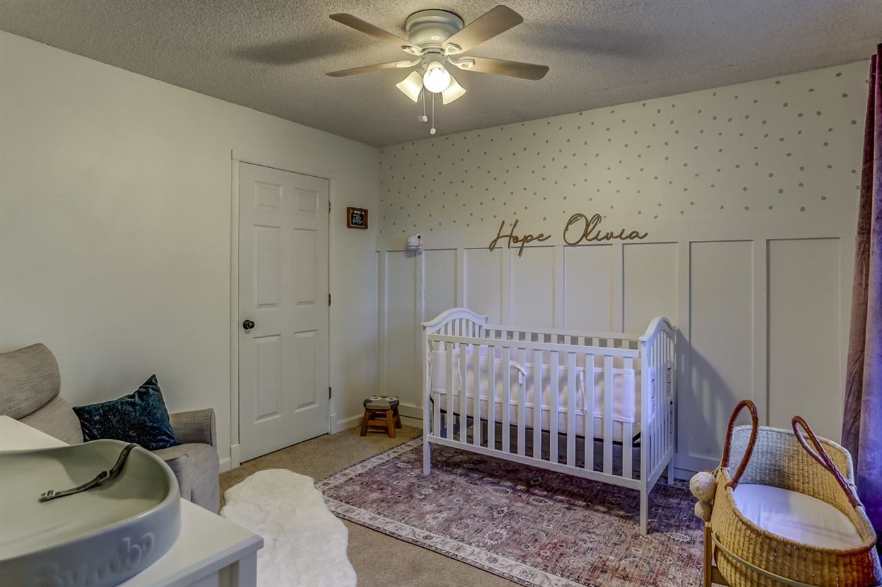 381 Rutledge Street Collierville, TN 38017 - Photo 19 of 23 a bedroom with bed and a chandelier