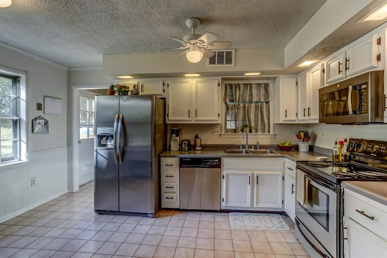 381 Rutledge Street Collierville, TN 38017 - Photo 10 of 23 a kitchen with stainless steel appliances granite countertop a stove sink and refrigerator
