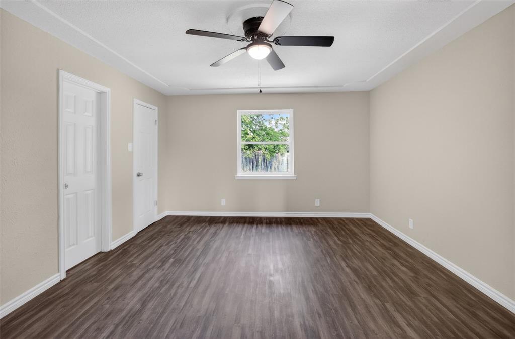 7528 Meadowlark Lane North Watauga, TX 76148 - Photo 20 of 31 a view of room with window ceiling fan and hardwood floor