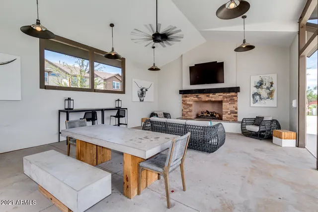 a living room with furniture a flat screen tv and kitchen view