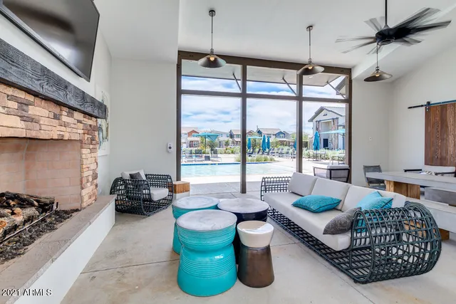 a living room with furniture ceiling fan and a rug