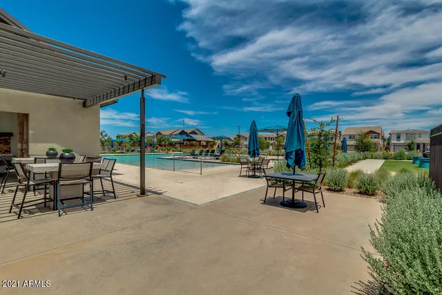 a view of a patio with a table and chairs under an umbrella with a patio