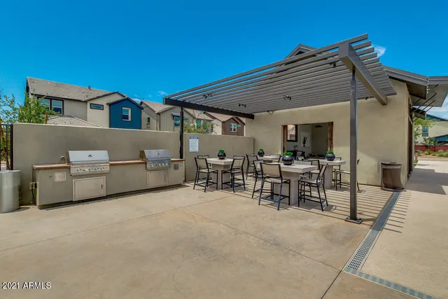 a view of a patio with table and chairs and potted plants