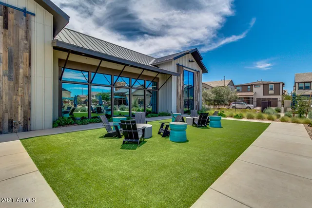 a view of an house with backyard porch and sitting area