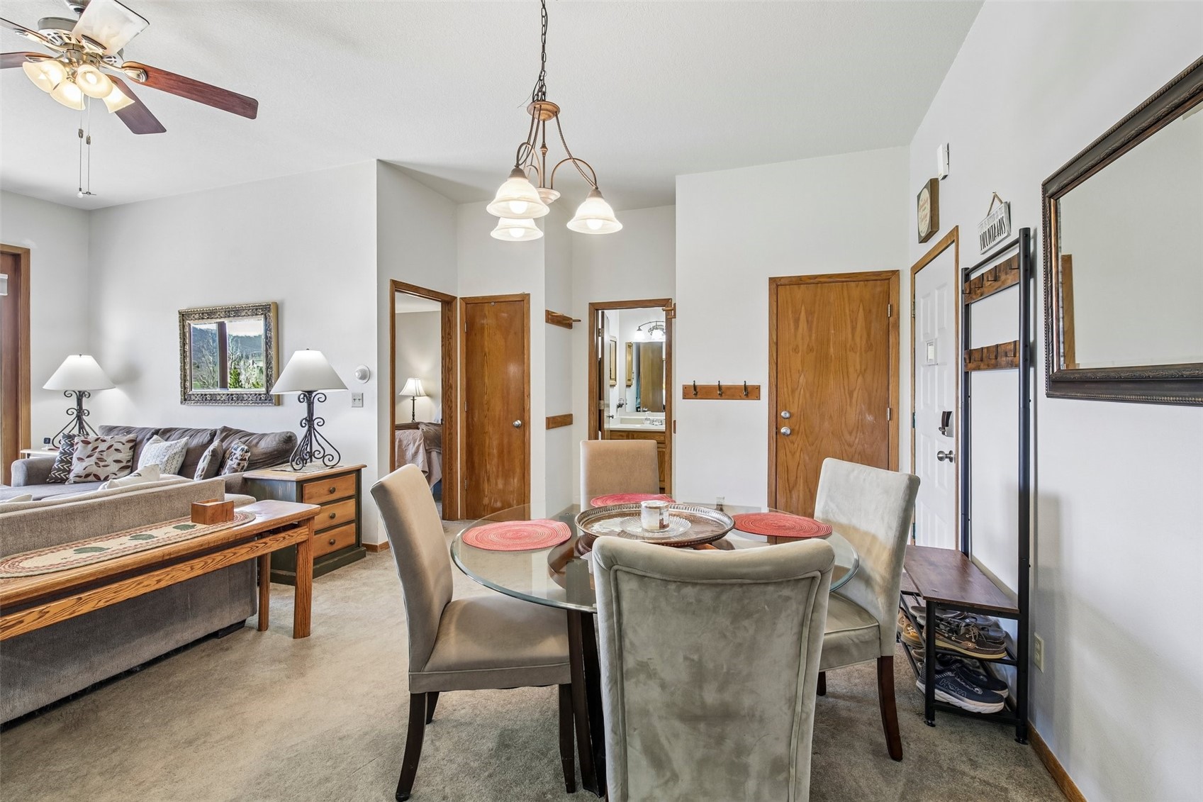 89310 Ryan Gulch Road, Unit 103 Silverthorne, CO 80498 - Photo 6 of 48 a outdoor dining room with furniture a chandelier and wooden floor