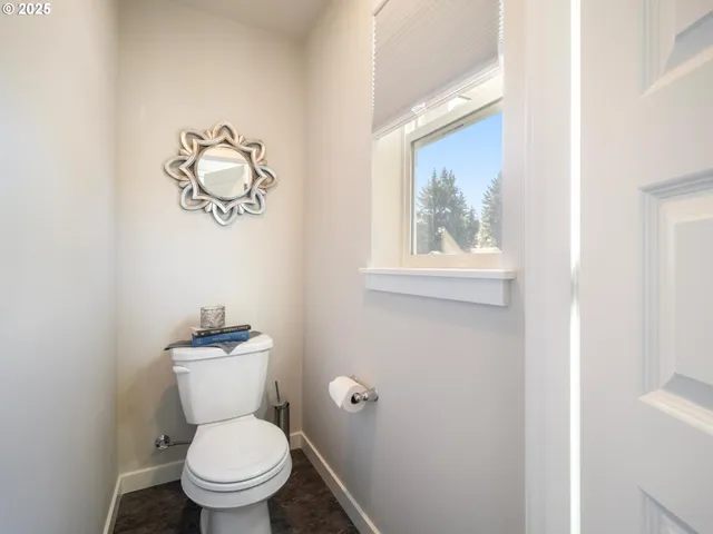 a white toilet sitting next to a bathroom sink