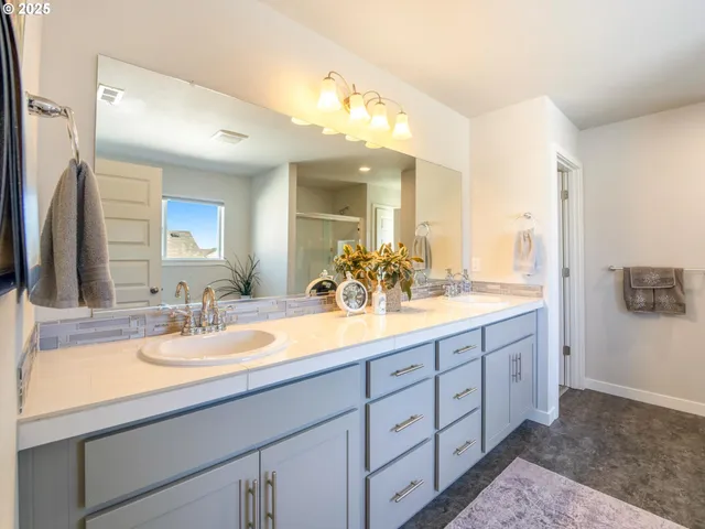a bathroom with a double vanity sink and a mirror
