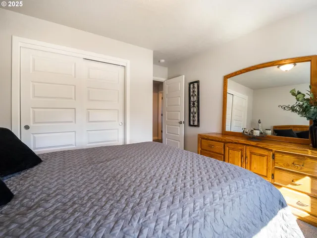 a bedroom with a bed and a dresser