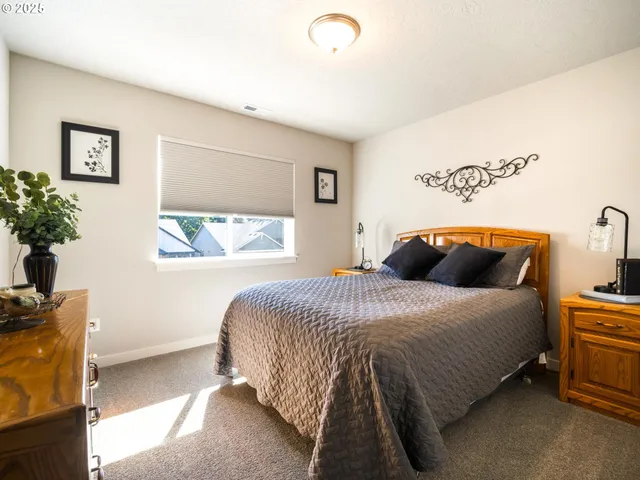 a bedroom with a bed and a potted plant