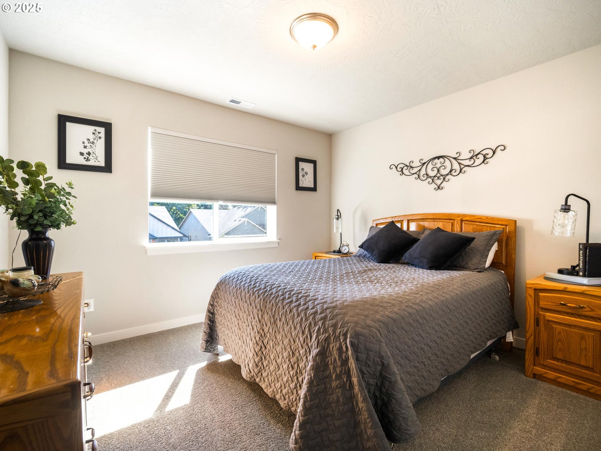 856 Maple Street Brownsville, OR 97327 - Photo 24 of 47 a bedroom with a bed and a potted plant