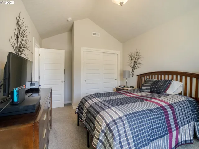 a bedroom with a bed and a flat screen tv