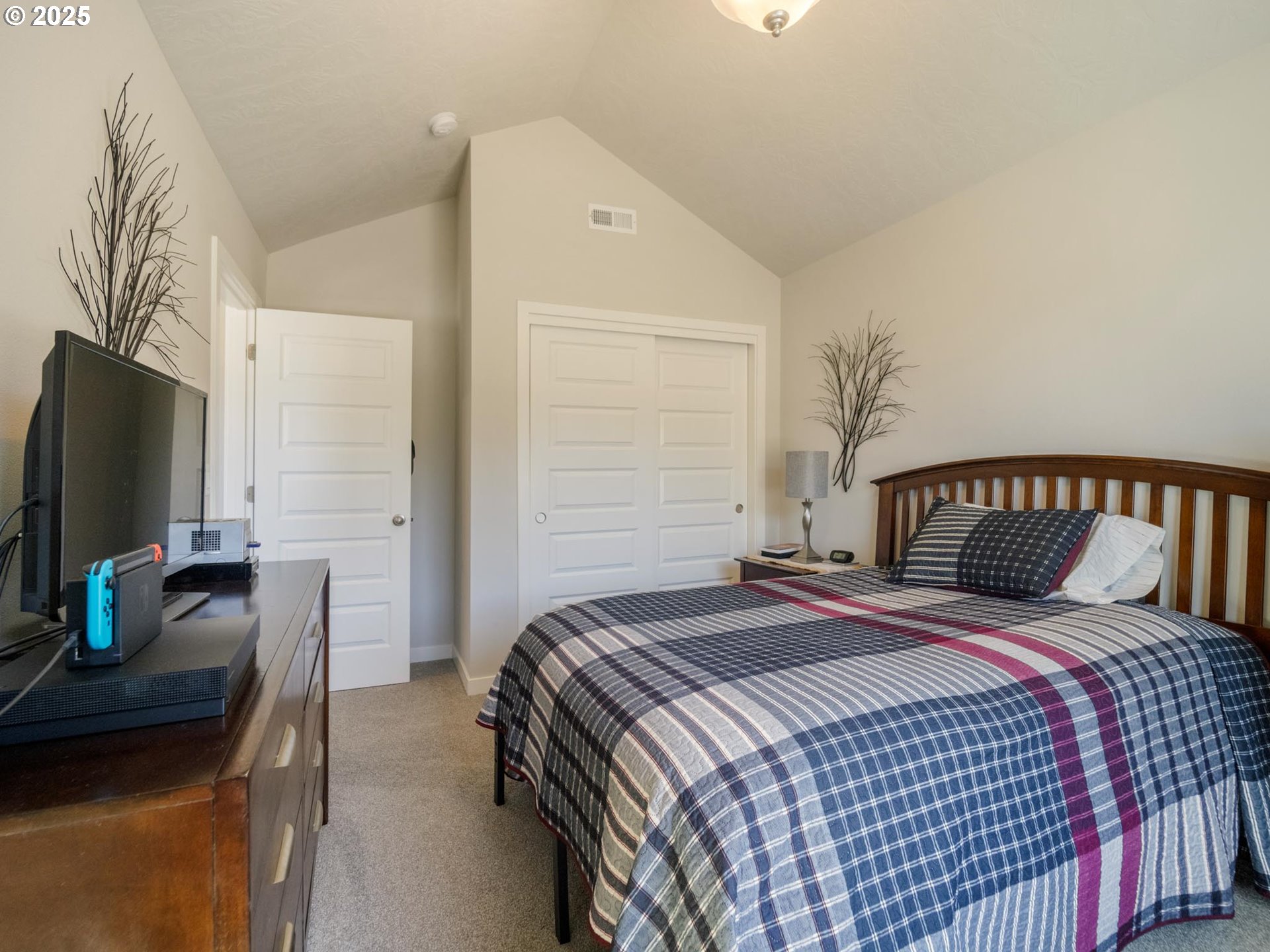 856 Maple Street Brownsville, OR 97327 - Photo 28 of 47 a bedroom with a bed and a flat screen tv