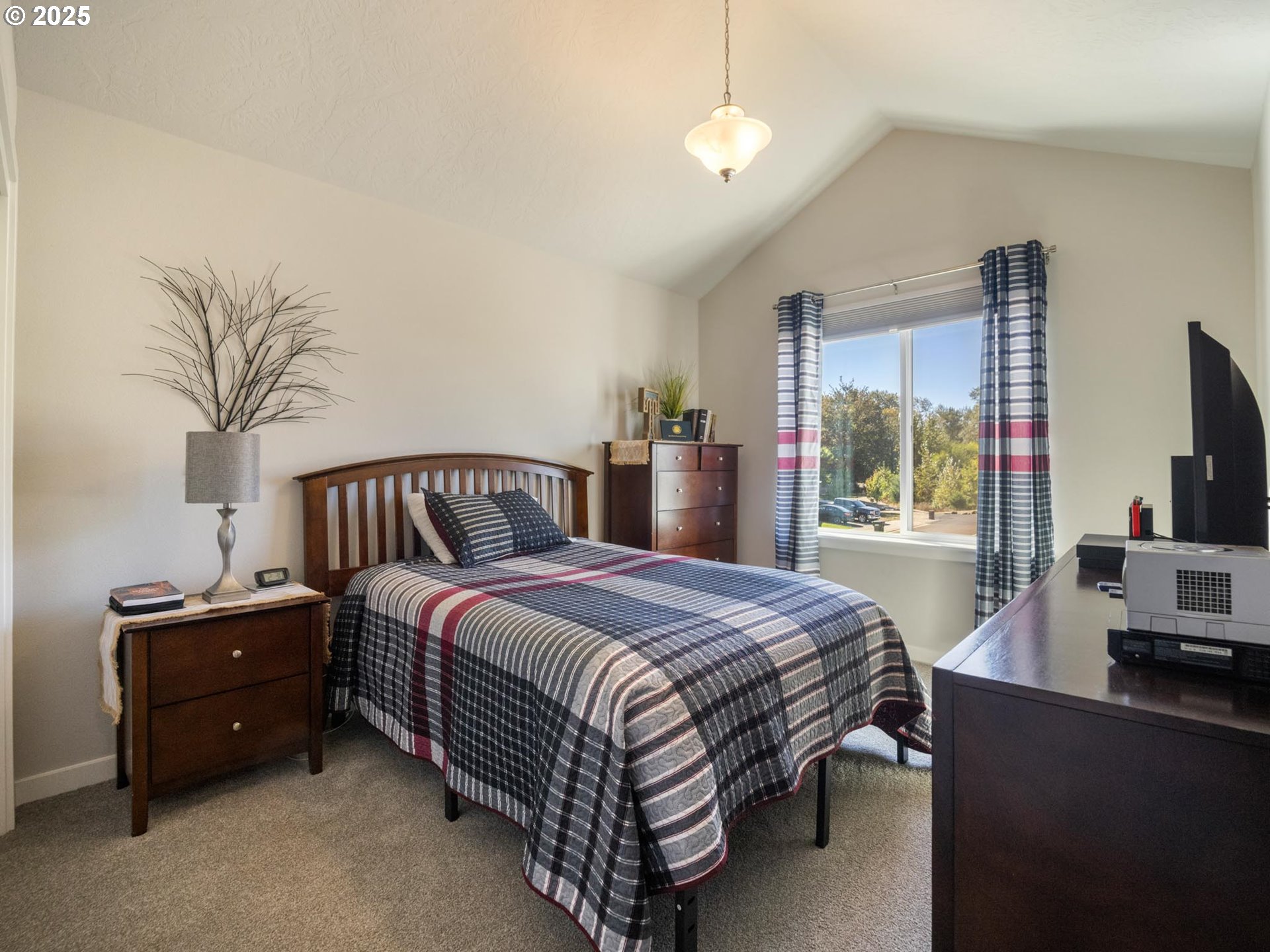 856 Maple Street Brownsville, OR 97327 - Photo 29 of 47 a bedroom with a bed and a flat screen tv
