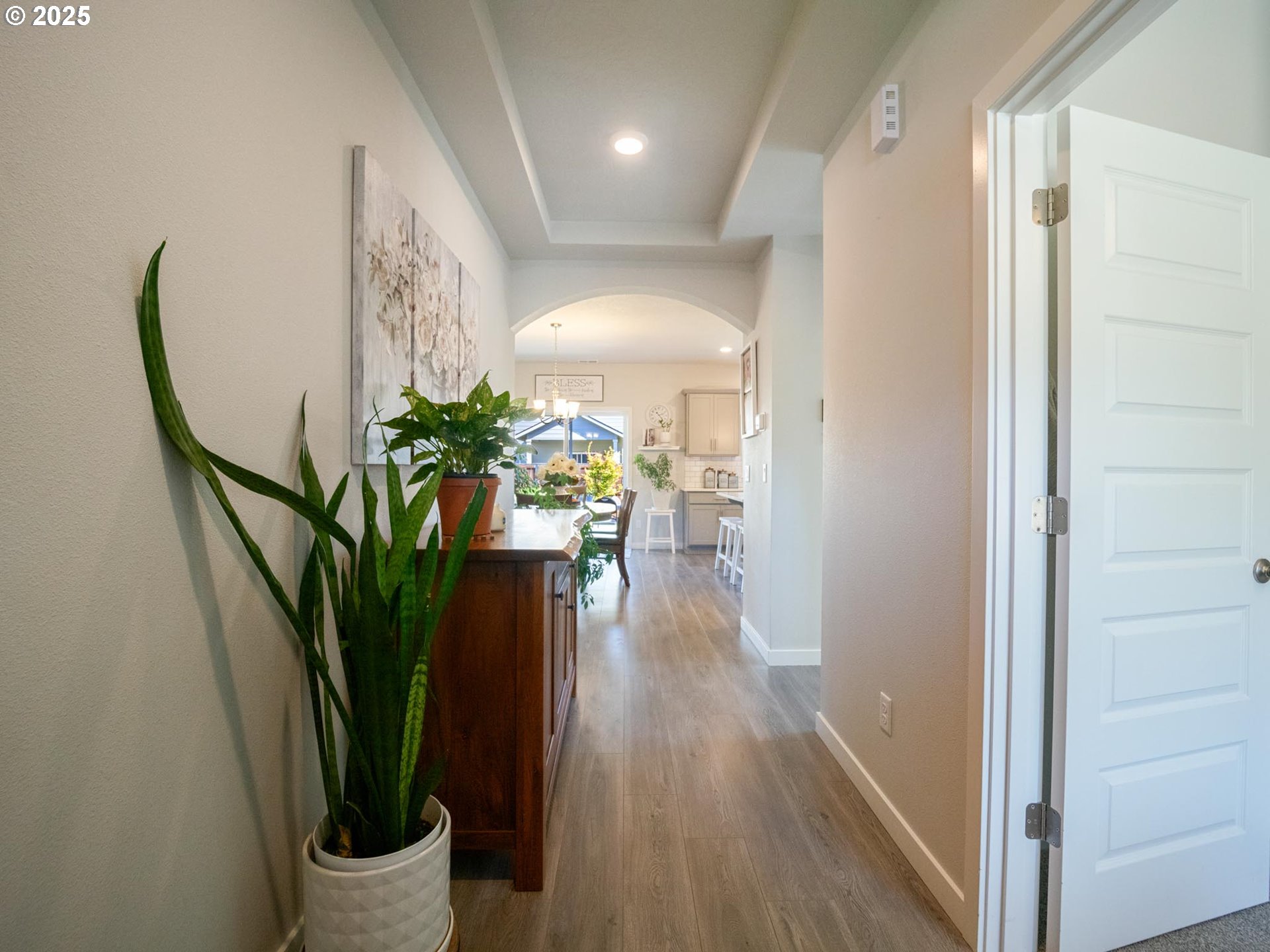 856 Maple Street Brownsville, OR 97327 - Photo 32 of 47 a view of a hallway with wooden floor and a potted plant