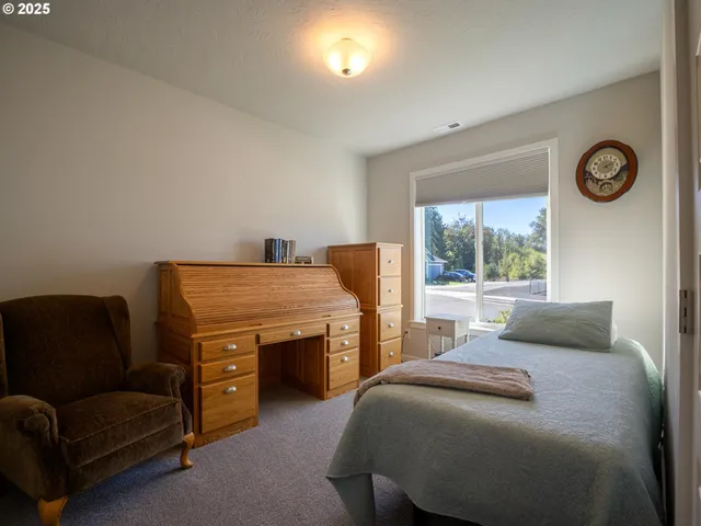 a bedroom with a bed and a couch