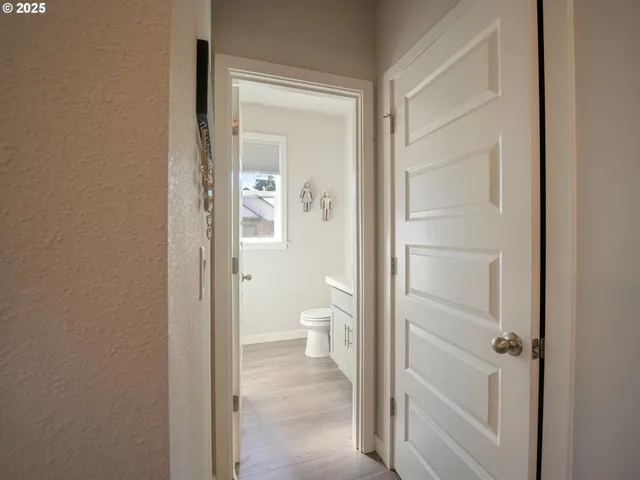 a view of a bathroom from the hallway with toilet