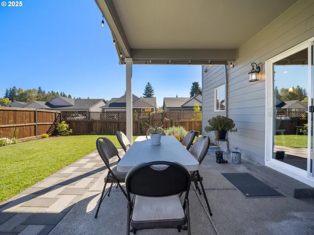 a view of a patio with table and chairs and potted plants