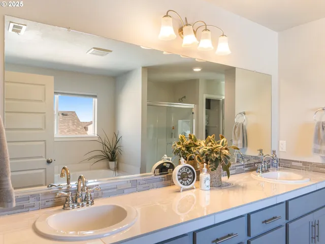 a bathroom with a double vanity sink and a mirror