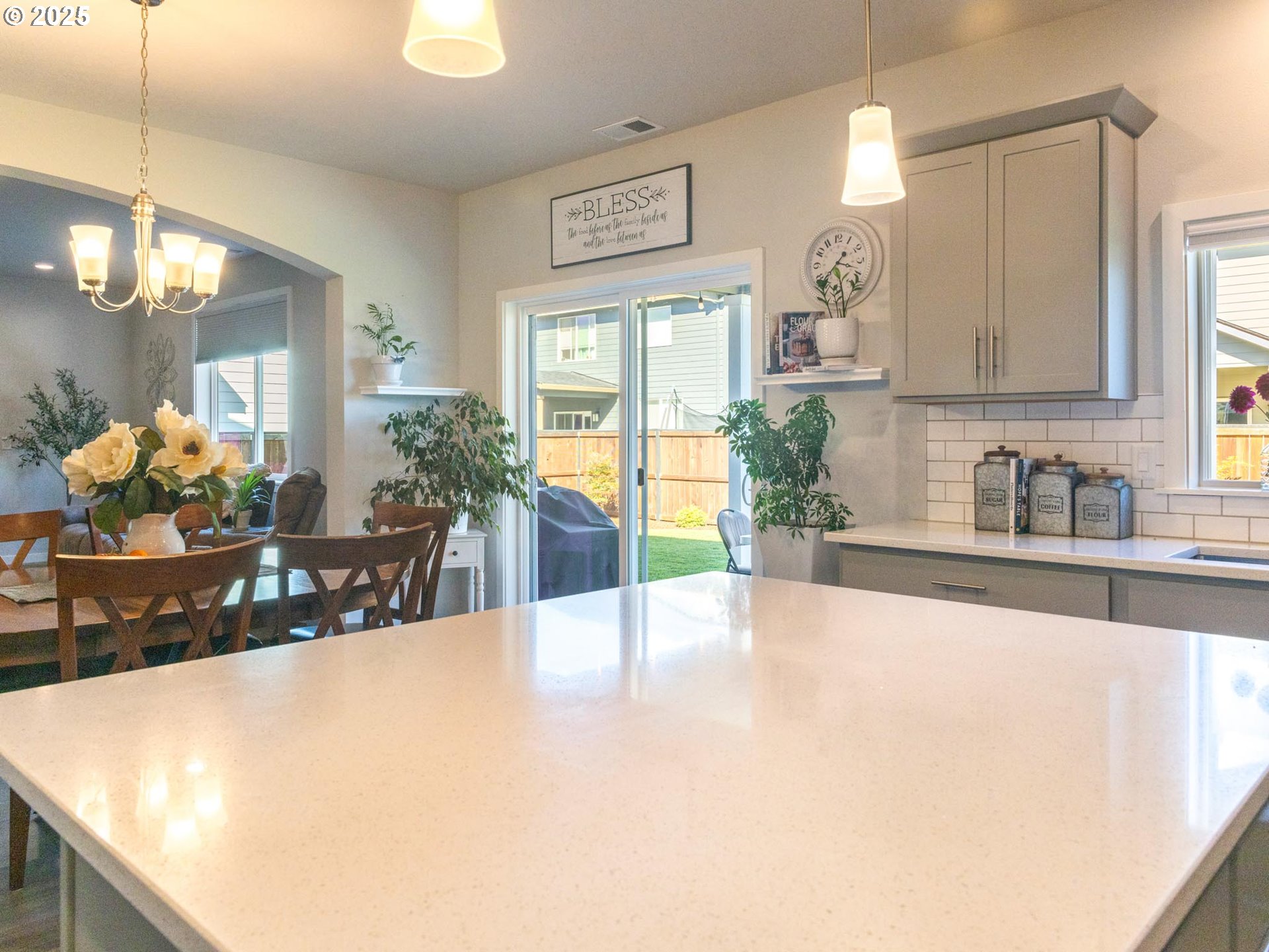 856 Maple Street Brownsville, OR 97327 - Photo 9 of 47 a large white kitchen with kitchen island granite countertop a sink a counter top space and living room view