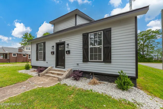 a front view of a house with garden