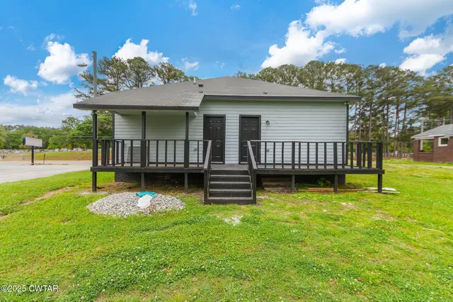 a view of a house with backyard porch and sitting area