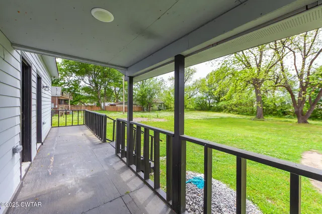 a view of outdoor space with deck and trees