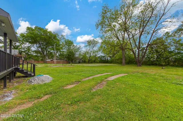 a view of a park with large trees