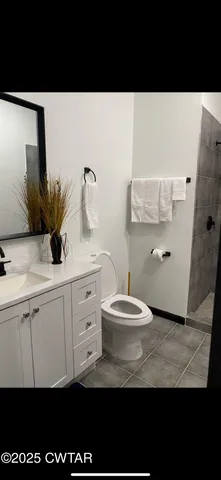 a bathroom with a sink a toilet and mirror