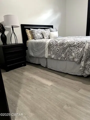 a bedroom with a bed and chair