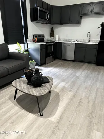 a kitchen with a refrigerator and a sink