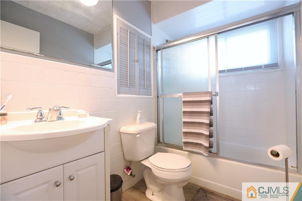 62 Stony Road Edison, NJ 08817 - Photo 11 of 26 a bathroom with a sink a toilet and shower