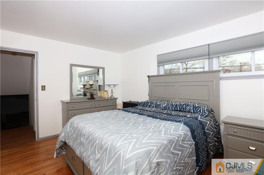 62 Stony Road Edison, NJ 08817 - Photo 12 of 26 a bedroom with a bed and a painting on the wall