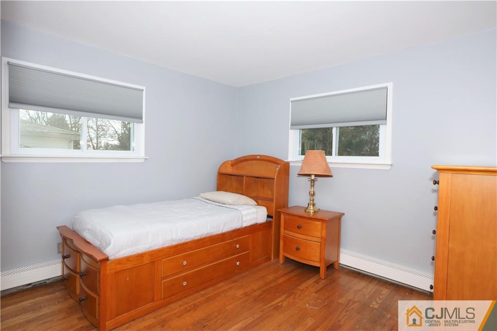 62 Stony Road Edison, NJ 08817 - Photo 13 of 26 a bedroom with a bed and wooden floor