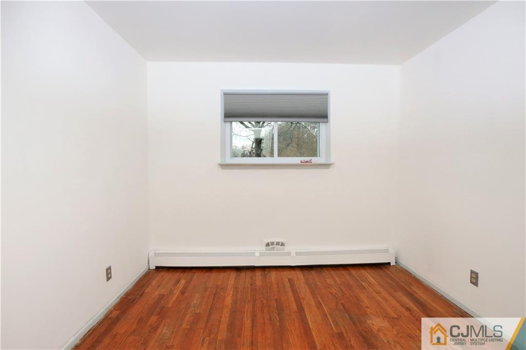62 Stony Road Edison, NJ 08817 - Photo 14 of 26 a view of a room with wooden floor and small window