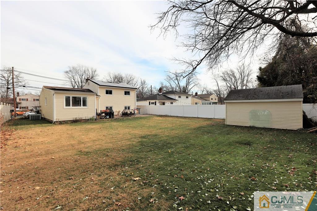 62 Stony Road Edison, NJ 08817 - Photo 19 of 26 a view of a white house with a big yard and large trees