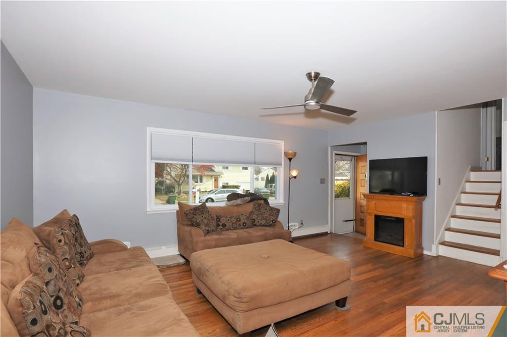 62 Stony Road Edison, NJ 08817 - Photo 4 of 26 a bedroom with furniture and a fireplace