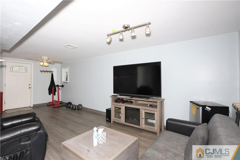 62 Stony Road Edison, NJ 08817 - Photo 6 of 26 a living room with furniture and a flat screen tv