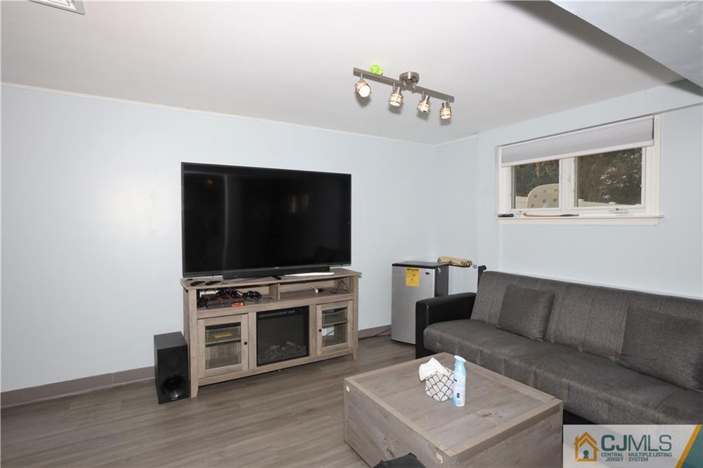 62 Stony Road Edison, NJ 08817 - Photo 7 of 26 a living room with furniture and a flat screen tv