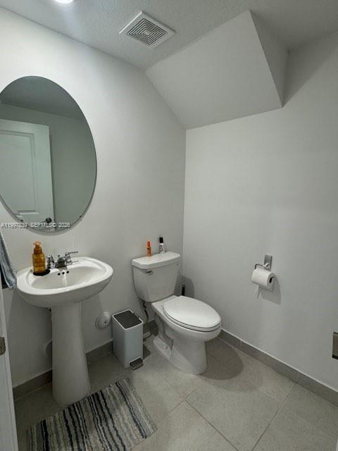 23012 Southwest 129th Place Miami, FL 33177 - Photo 6 of 9 a bathroom with a toilet sink and mirror