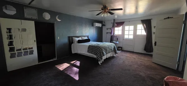 a spacious bedroom with a bed and a window