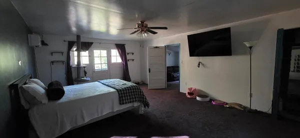 a bedroom with a bed and a flat screen tv