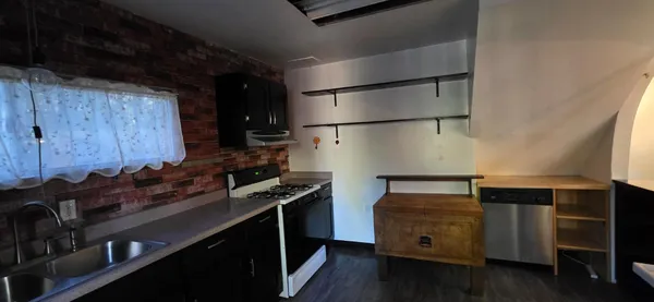 a kitchen with stainless steel appliances a refrigerator and a stove top oven