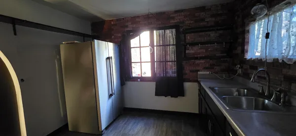 a kitchen with a sink a refrigerator and window