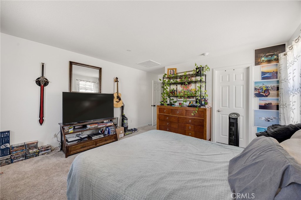21192 Telegraph Road Riverside, CA 92507 - Photo 11 of 35 a bedroom with a bed and a flat screen tv
